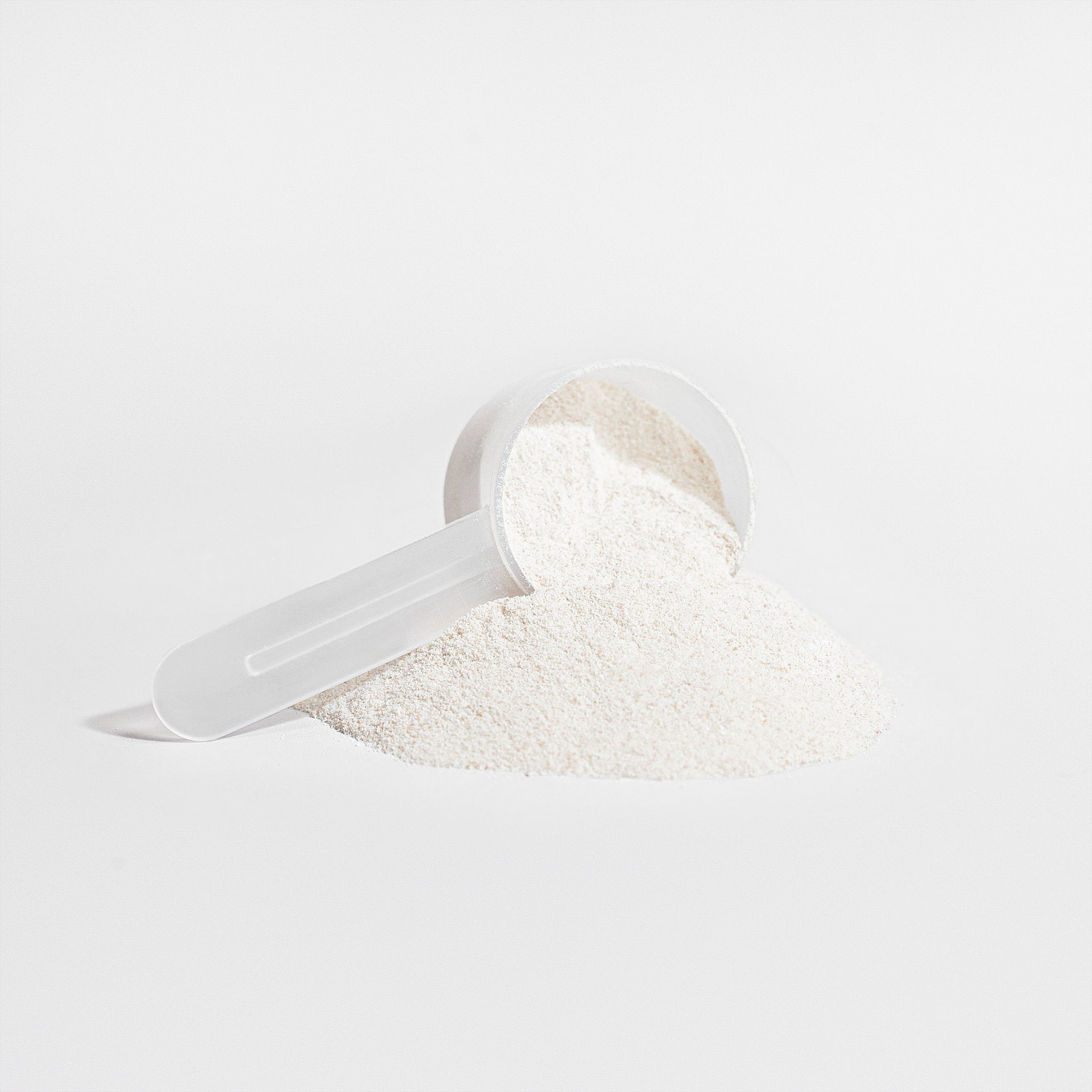 Alpha Omega Vitality grass-fed collagen peptides in powdered form with a scoop for easy measurement