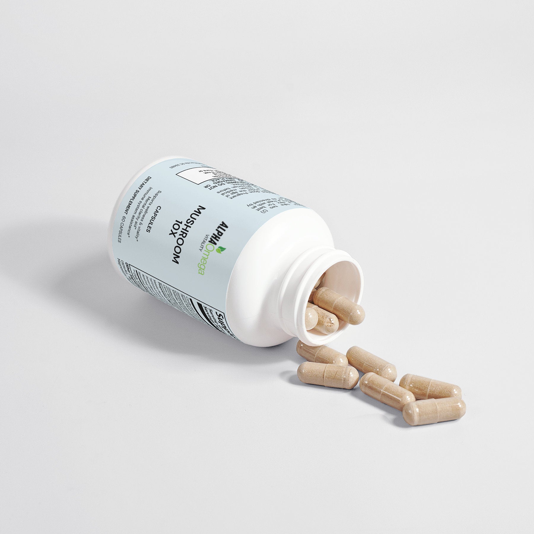 Alpha Omega Vitality Mushroom Complex Supplement Bottle with Spilled Capsules on White Background