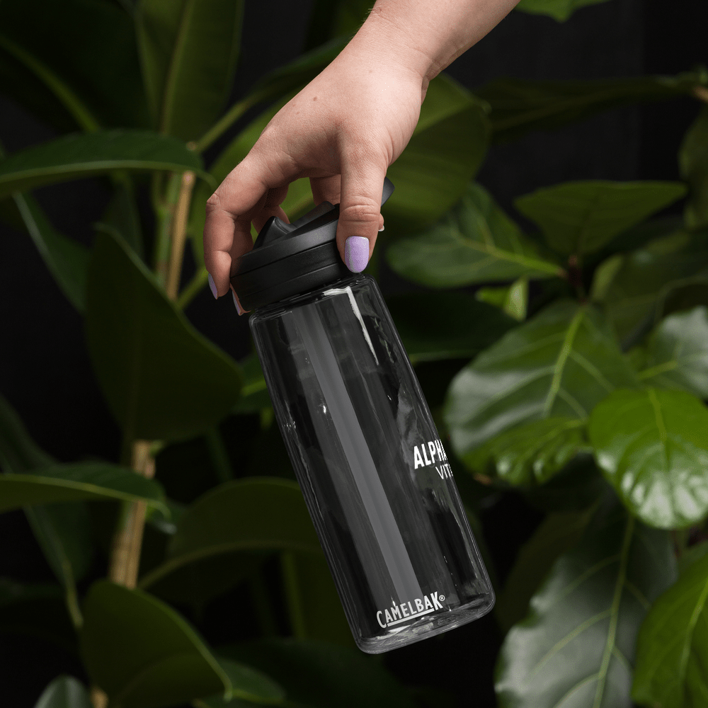 Alpha Omega Vitality premium sports water bottle held against a background of green leaves