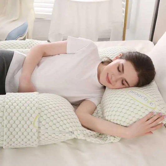 Woman peacefully sleeping on a comfortable pregnancy pillow for optimal support and comfort